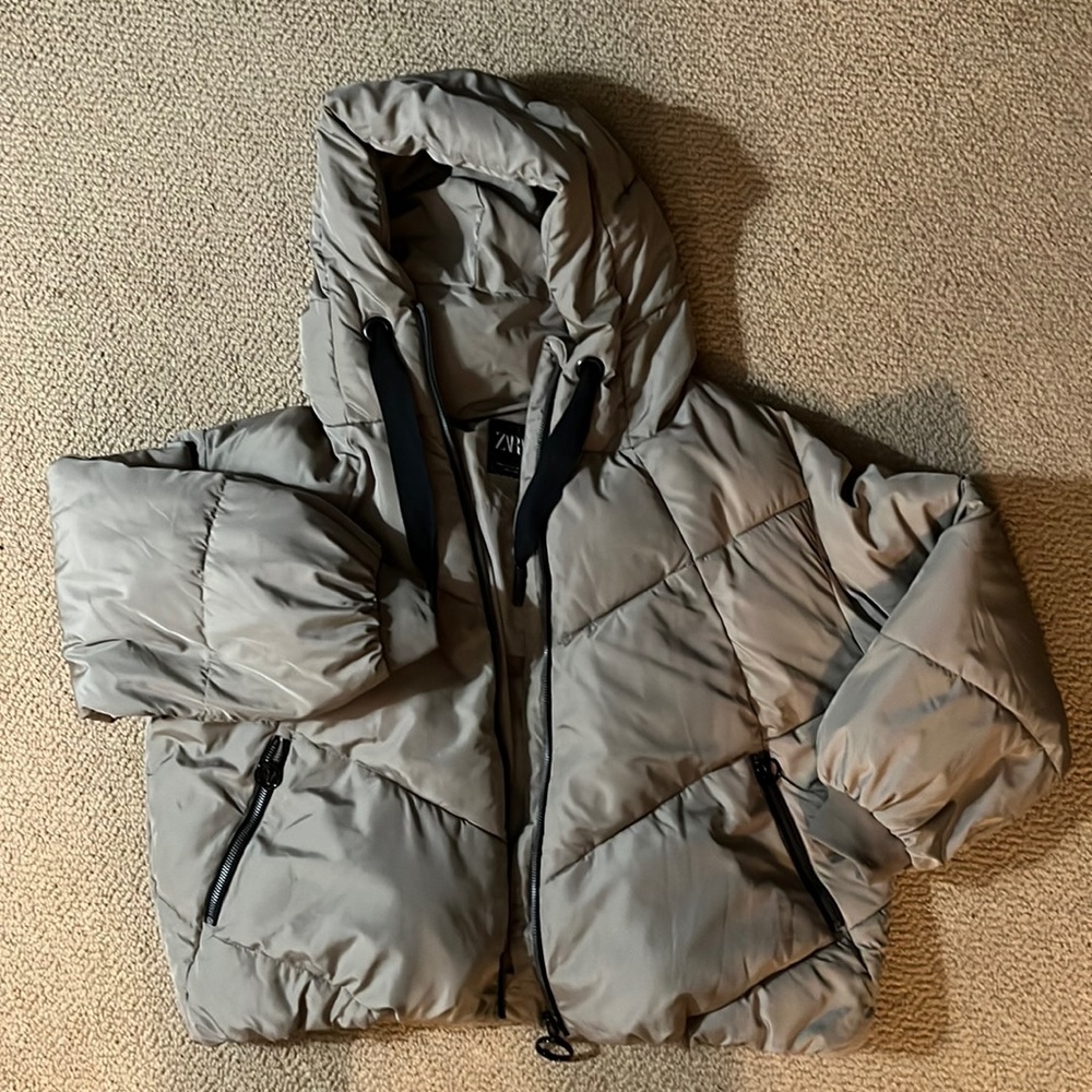 Tan puffer jacket with hood.